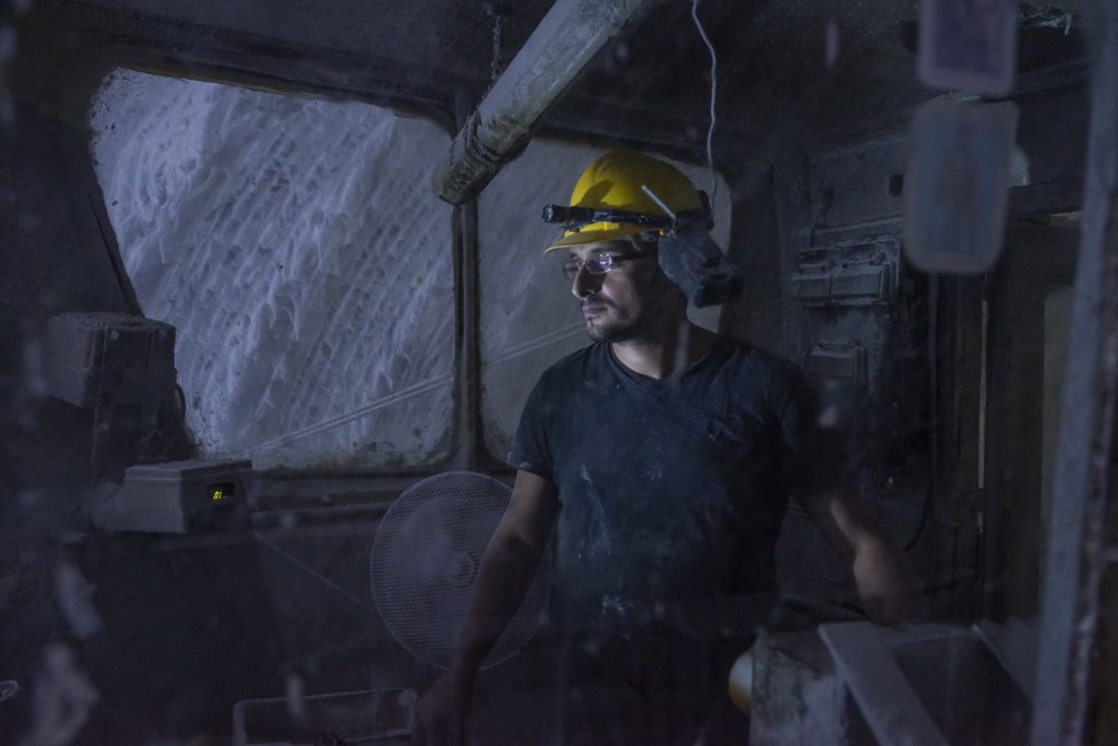 Miner operating the milling machine