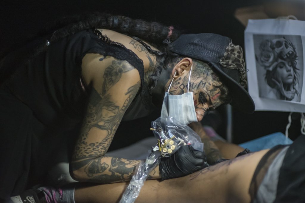 Manzana tattooing in her house